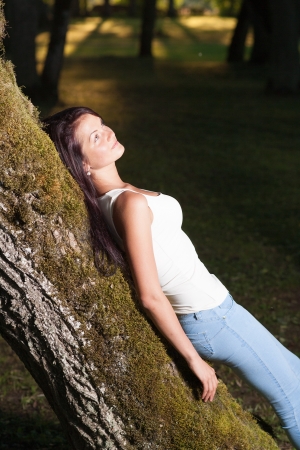Beutiful woman in green parkの写真素材