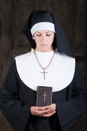 Nun with Bible looking downの写真素材