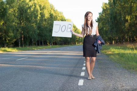 Woman hitchhikes for jobの写真素材