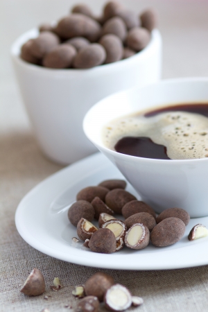 Breakfast with coffee and chocolate covered almondsの写真素材