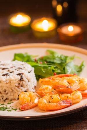 Grilled shrimps with rice in romantic atmosphereの写真素材