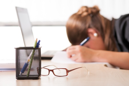 Exhausted woman sleeping at workの写真素材