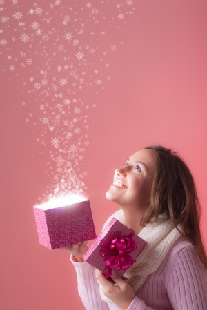 Beautiful woman opens her christmas presentの写真素材