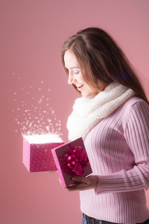 Beautiful woman opens her christmas presentの写真素材