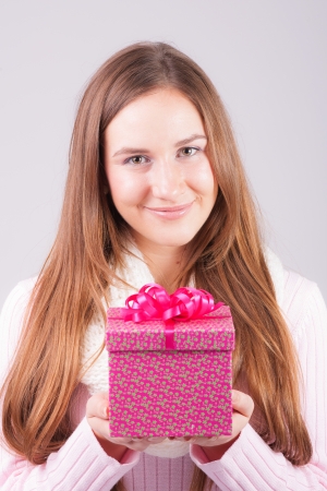 Beautiful woman holding giftの写真素材