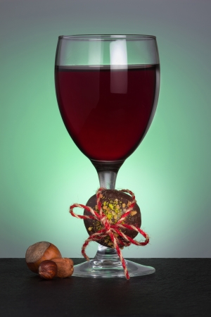 Chocolate candy, nuts and wineglassの写真素材
