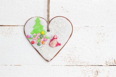Gingerbread hanging on white wooden wallの写真素材