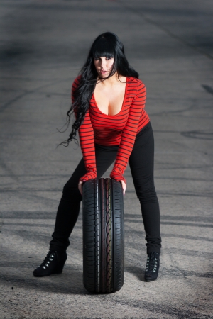 Attractive woman and car tireの写真素材