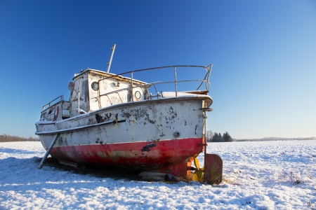 Boat on ground in winterの写真素材
