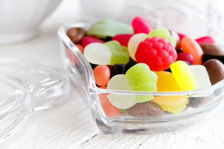 Colourful candies in heart shaped dishの写真素材