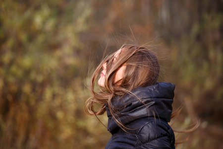 Messy hair of woman, windy autumn dayの写真素材