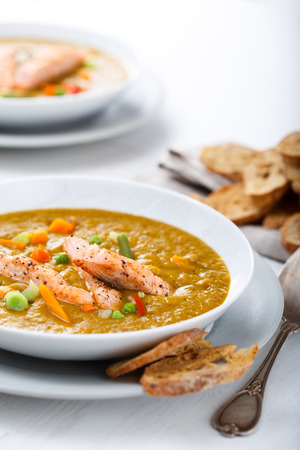 Healthy puree soup with salmon and white bread snacksの写真素材
