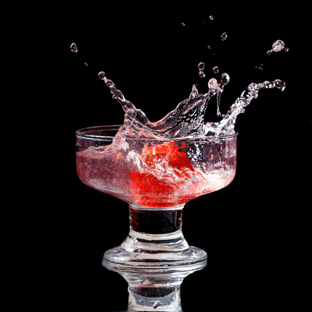 Strawberry splash isolated on black backgroundの写真素材
