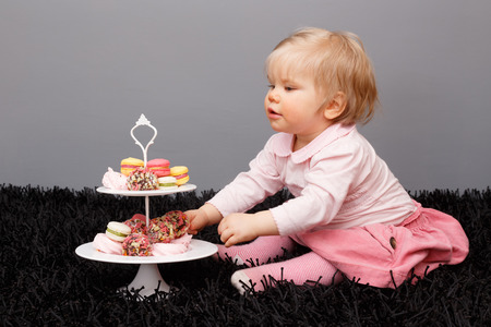 Little girl and sweetsの写真素材