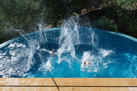 Men having fun in poolの写真素材