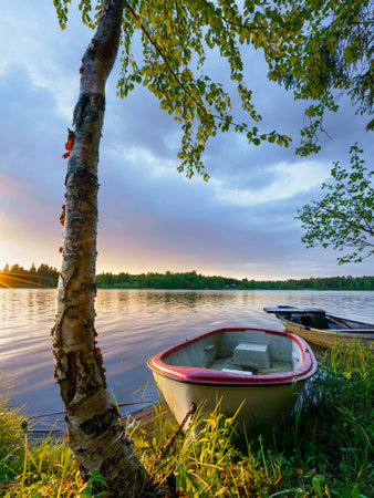 Beautiful evening sunset view to lake and rowing boatsの写真素材