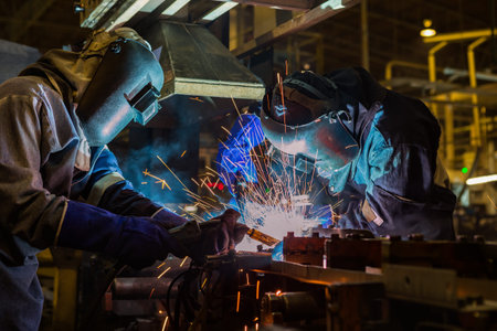 Team welder are welding in car factory