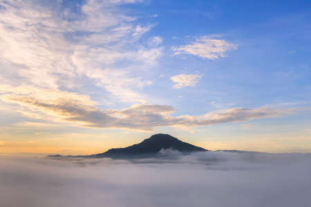 Sunrise over fog in the morningの写真素材