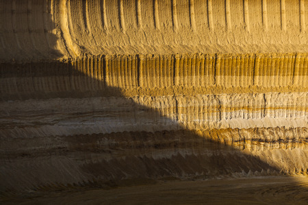A steep lignite pit mine wall in warm evening lightのeditorial素材