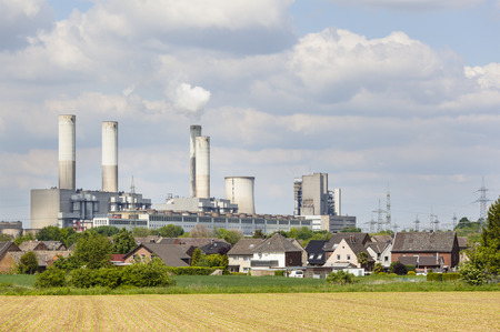A decommissioned lignite power station behind a villageのeditorial素材