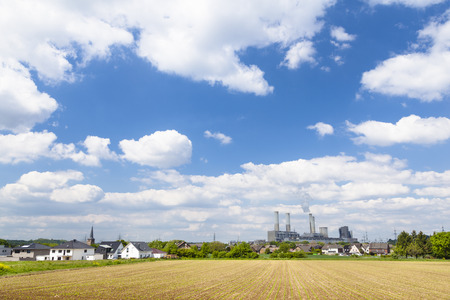 A decommissioned lignite power station behind a villageのeditorial素材