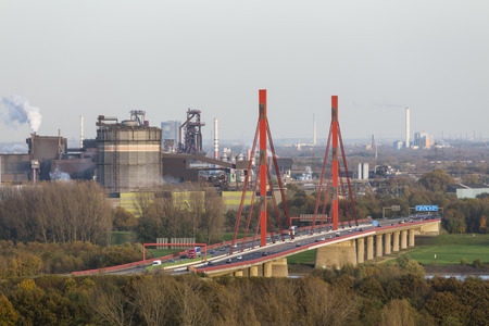 Steel Plant at the river Rhine near Duisburg, Germany with the motorway bridge of the A42 in the foreground.のeditorial素材