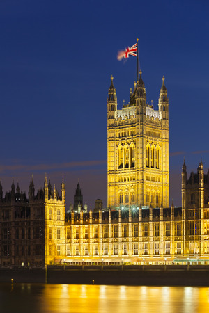 Long exposure night shot of the Houses of Parliament in London with blue sky and the Westminster Bridge in the foreground.の写真素材