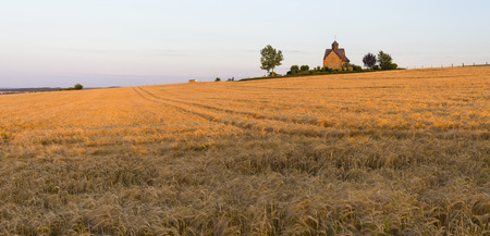 A little chapel on a hill in warm evening light in the North Eifel in Germany.の写真素材