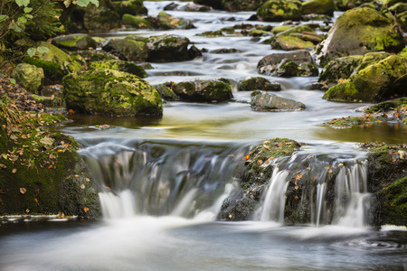Little waterfalls in a mountain river in the High Fens, Ardennes, Belgium, long exposure shotの写真素材