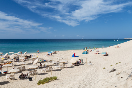 FUERTEVENTURA - OCTOBER 20: The endless Jandia Beach in Fuerteventura, Spain with some tourists at a dune on October 20, 2013のeditorial素材