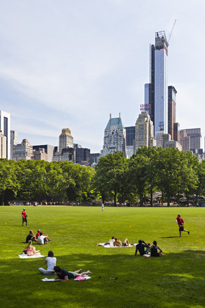 New York City - June 22: Tourist and locals enjoying the sun at the baseball fields in Central Park in New York on June 22, 2013のeditorial素材
