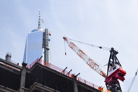 New York City - June 22: The almost finished One World Trade Center in New York with blue sky and construction site on June 22, 2013のeditorial素材