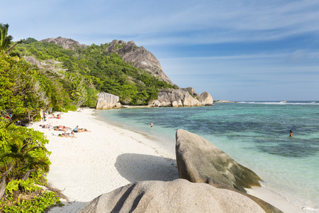 LA DIGUE - AUGUST 15: Tourists on the beach at Anse Source D'Argent in La Digue, Seychelles on August 15, 2014のeditorial素材