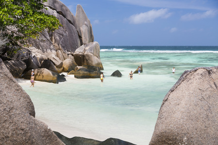 LA DIGUE - AUGUST 15: Tourists on the beach at Anse Source D'Argent in La Digue, Seychelles on August 15, 2014のeditorial素材
