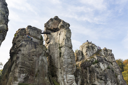 HORN-BAD MEINBERG - OCTOBER 04: Tourists on top of the famous sandstone rock formation Externsteine in autumn in Germany on October 4, 2015のeditorial素材