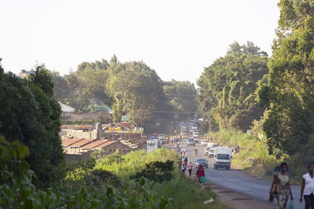 Kikuyu, Kenya - February 8: Rush hour on a main road in Kikuyu near Nairobi, Kenya with traffic and pedestrians passing on February 8, 2013のeditorial素材