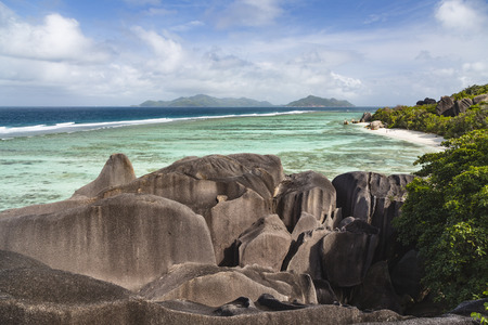 High angle view of the famous Anse Source D'Argent in La Digue, Seychelles from an observation point with granite rocks in the foregroundの写真素材