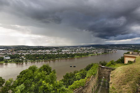 View along the Rhine valley in Koblenz, Germany with dark rain clouds seen from Ehrenbreitstein.の写真素材