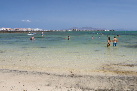 FUERTEVENTURA - SEPTEMBER 20: Tourists enjoying the warm water of the Atlantic Ocean at a Corralejo City beach in Fuerteventura, Spain on September 20, 2015のeditorial素材