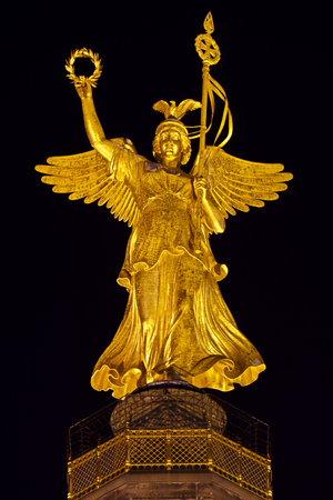 The statue of Victoria on top of the Victory Column (Siegessaeule)  in Berlin at night.の写真素材