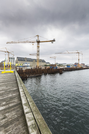 Dark clouds over a large construction site for a new Metro line at Larsens Plads in Copenhagen, Denmark.のeditorial素材