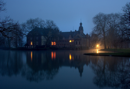 Castle Darfeld, Germany in winter with slight fog at night.のeditorial素材