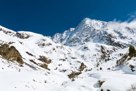 View to the 3500m high Schrankogel in the Oetztal, Austria with snow covered landscape and blue sky.
