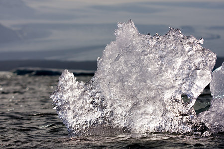 An iceberg in the Joekulsarlon glacier lagoon against the sunlight, Iceland.
