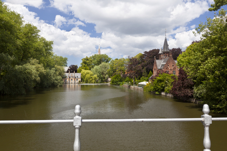 The romantic lake Minnewater with its little castle in the south of Bruges, Belgium.のeditorial素材