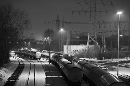 Winter night shot of an industrial railroad yard with several trains.のeditorial素材