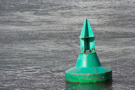 A green buoy in the water.の写真素材
