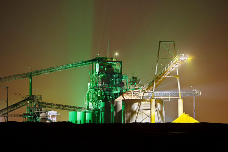 A gravel plant at night with colorful illumination.