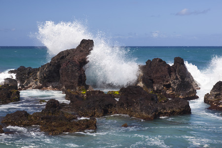 Waves splashing on the Hookipa rocks in northern Maui, Hawaii.の写真素材