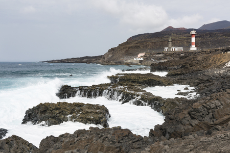 The two lighthouses in Fuencaliente, La Palma, Spain with tall waves on the rocks.の写真素材